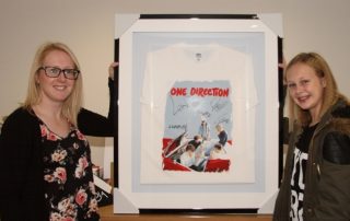 Paige shows off her framed One Direction T-shirt