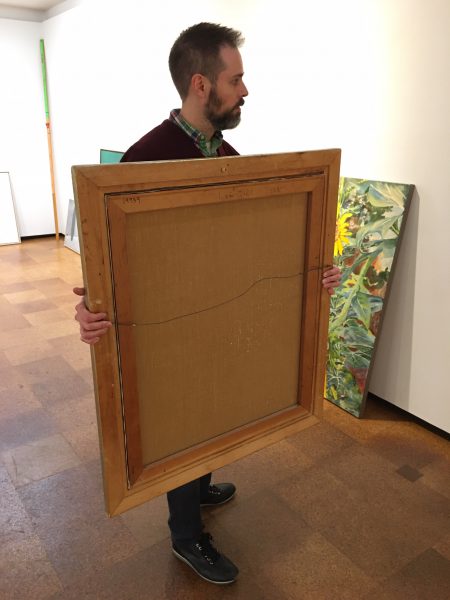 Always pick up and carry your artwork with two hands. Hold firmly by the sides. Never pick up artwork by the top rail of the frame, particularly when using slim frames which can lift, bow, loosen the glass and break the sealed package.
