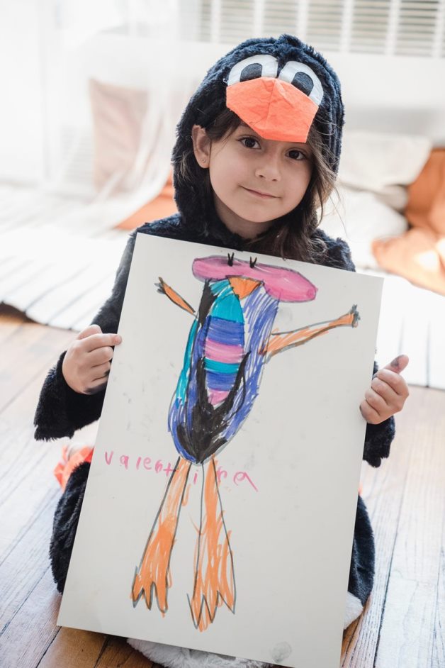 Child showing her finished drawing