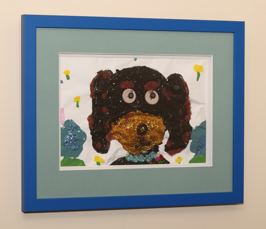 Child's drawing of a dog using glitter & buttons for eyes