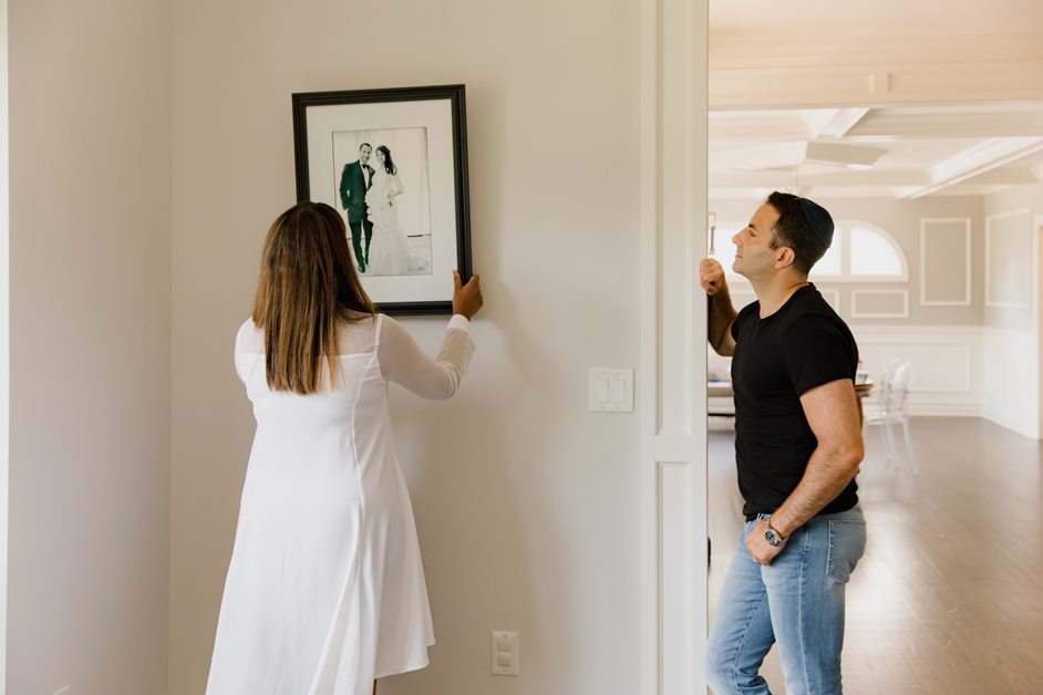 Couple deciding where to hang their artwork.